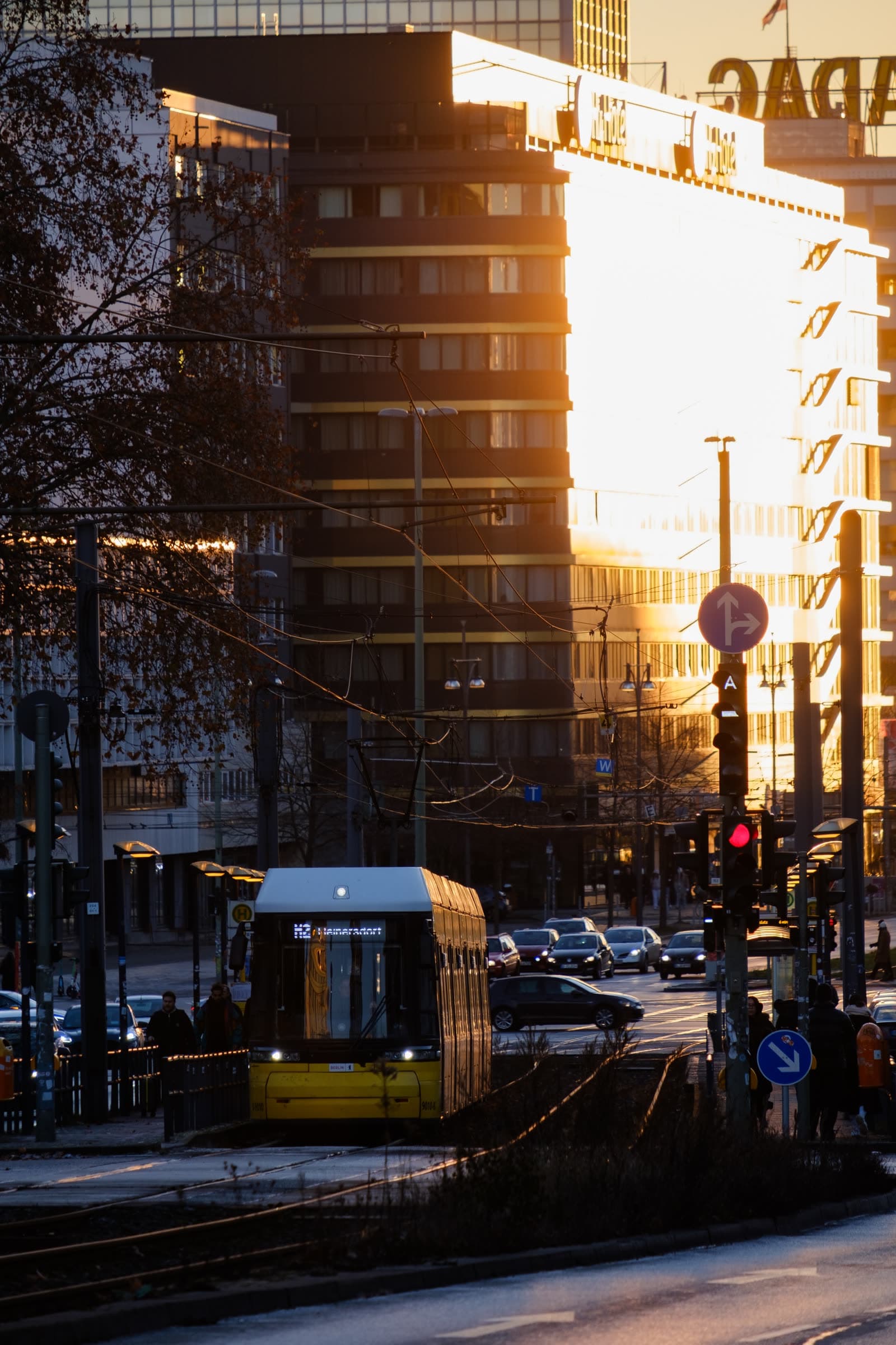 Un tram jaune dans une rue de Berlin baignée de lumière rasante